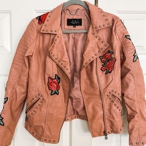 Womens faux leather biker style jacket. Rose embroidery. Stud accents.